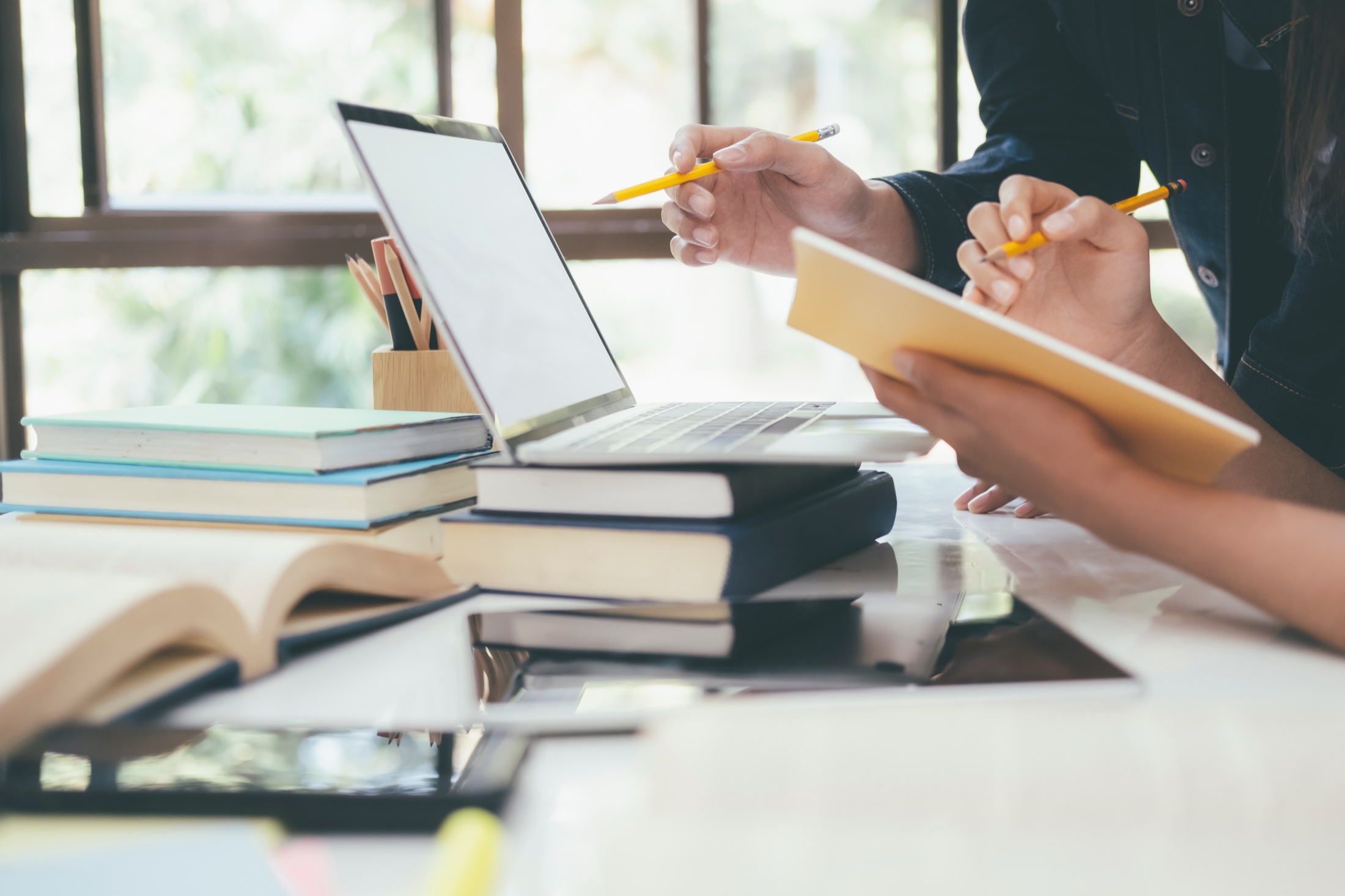 Studying with books and a laptop